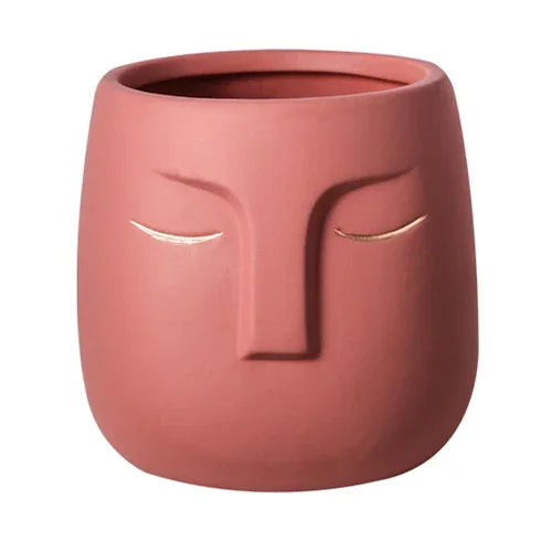 Vaso de cerâmica com rosto